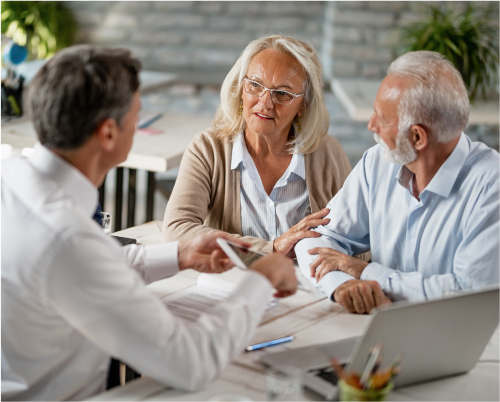 An elderly couple meeting with a financial advisor